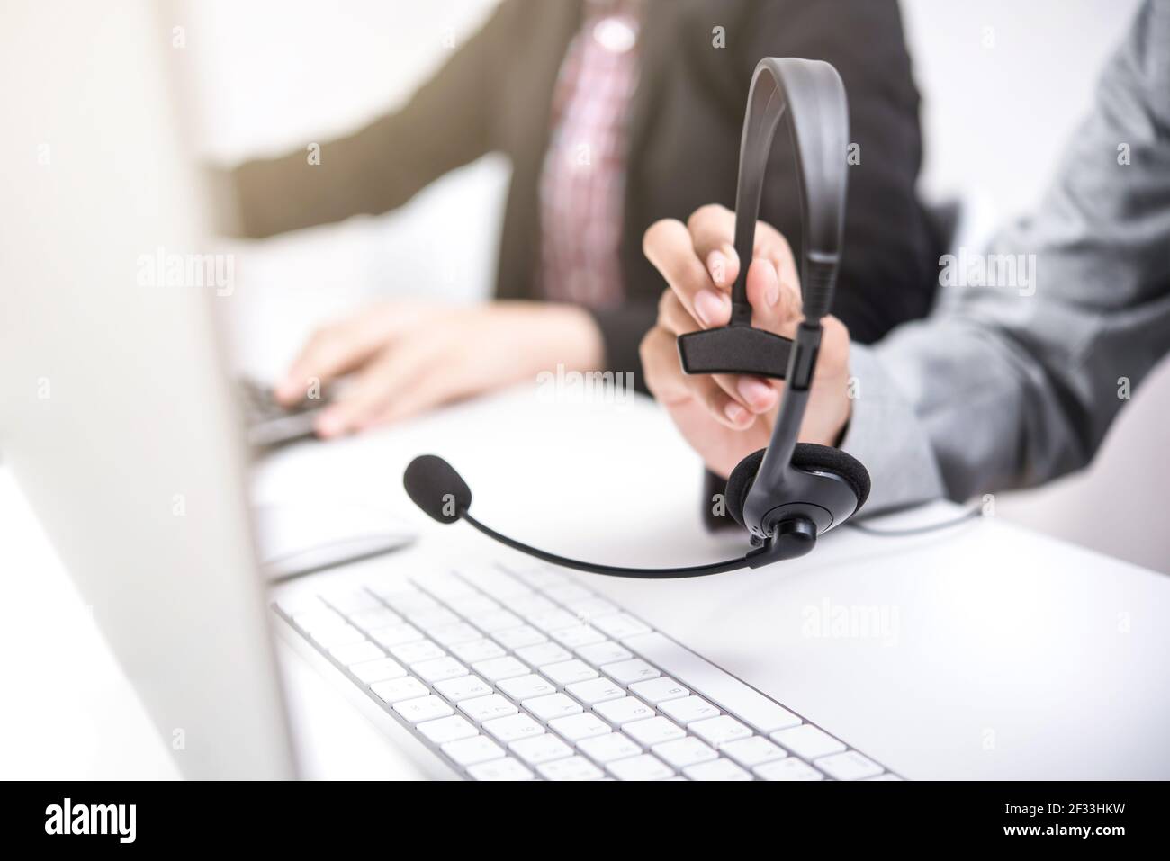 Woman hand holding microphone headset  in call center Stock Photo