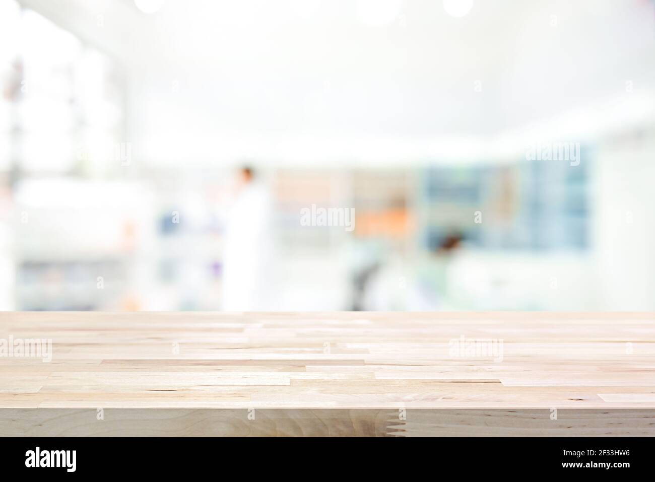 Empty wood counter top on blur pharmacy (chemist or cosmetic shop) background Stock Photo