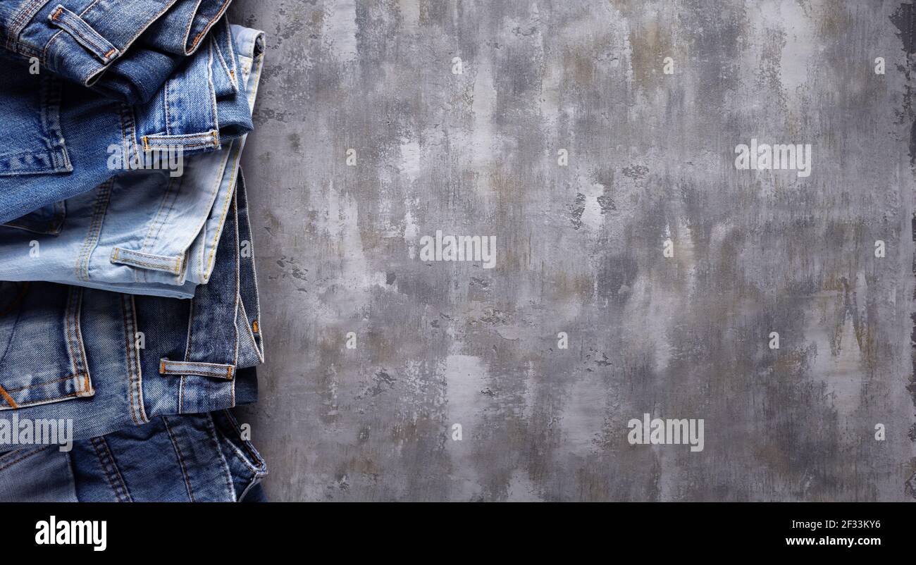 Denim jeans on old abstract background texture of table surface Stock Photo