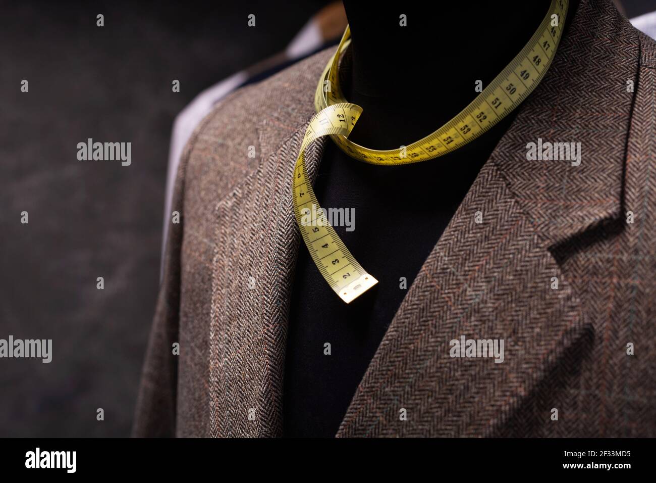 Suit jacket on male tailor mannequin and tape measure, creative concept ...