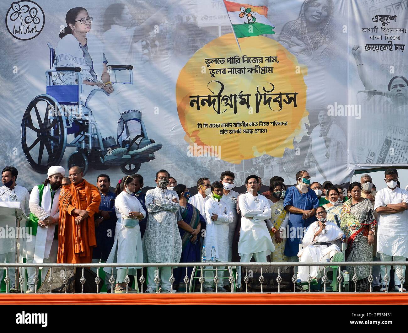 Kolkata, India. 14th Mar, 2021. Chief Minister of West Bengal and Trinamool Congress Supremo Mamata Banerjee addresses a rally while sitting on a wheel-chair to observe Nangiram Diwas. Trinamool Congress Supremo Mamata Banerjee attended her first public event, after she was injured and hospitalised during election campaign in Nandigram four days ago in Kolkata. (Photo by Sanjay Purkait/Pacific Press) Credit: Pacific Press Media Production Corp./Alamy Live News Stock Photo