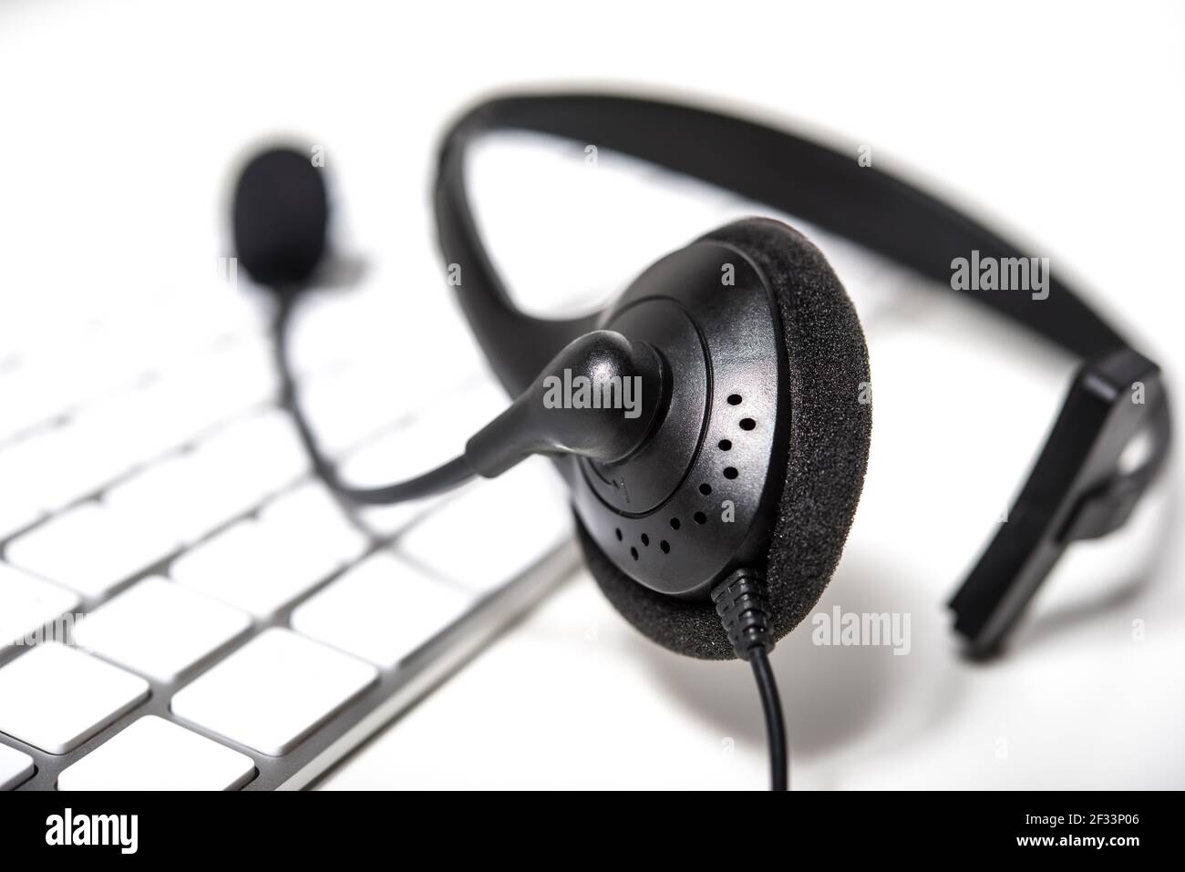 Microphone headset on computer keyboard Stock Photo Alamy
