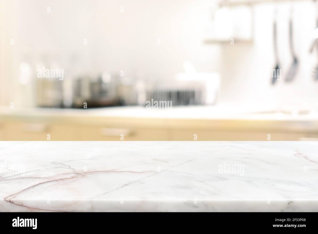Marble stone table top (kitchen island) on blur kitchen interior background - can be used for display or montage you products Stock Photo