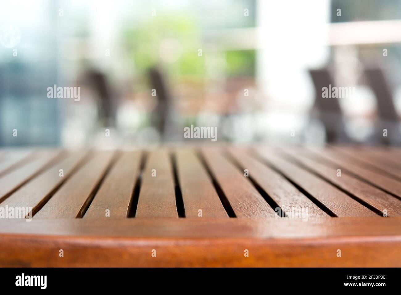 Empty round wood table top in outdoor cafe - can be used for mintage foods and products Stock Photo