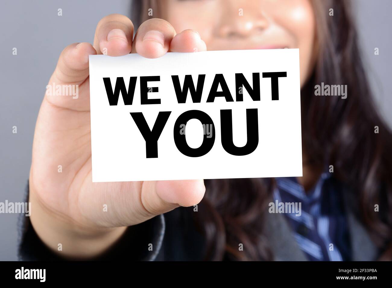 WE WANT YOU! message on the card shown by a businesswoman Stock Photo