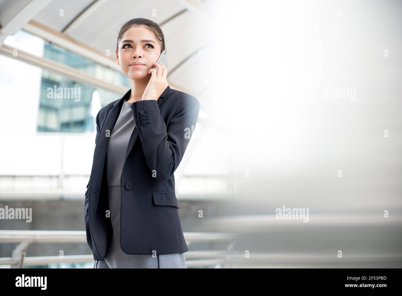 Young Asian businesswoman using smartphone Stock Photo