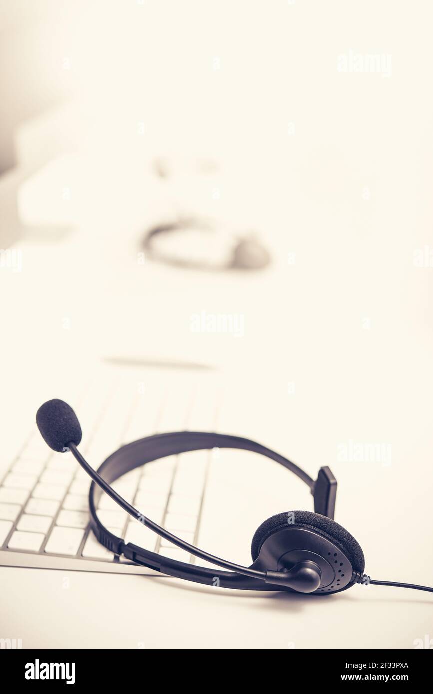 Microphone headsets on the table with computer keyboard call center
