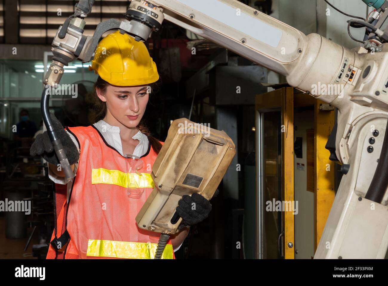 Smart factory job worker control robotic arm in manufacturing