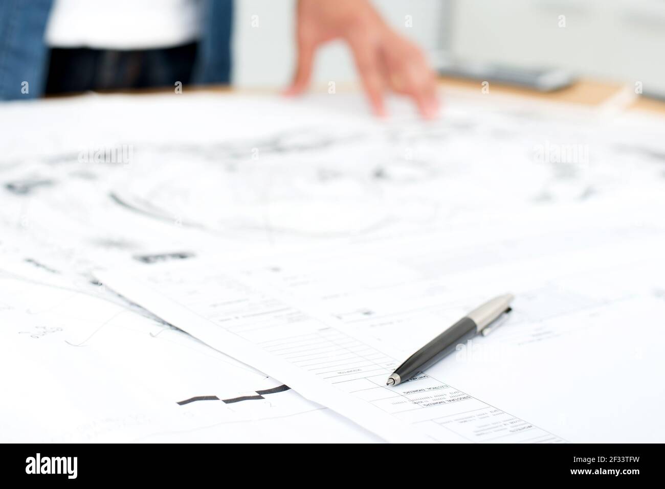 Pen and architectural blueprints on the table - selective focus Stock Photo