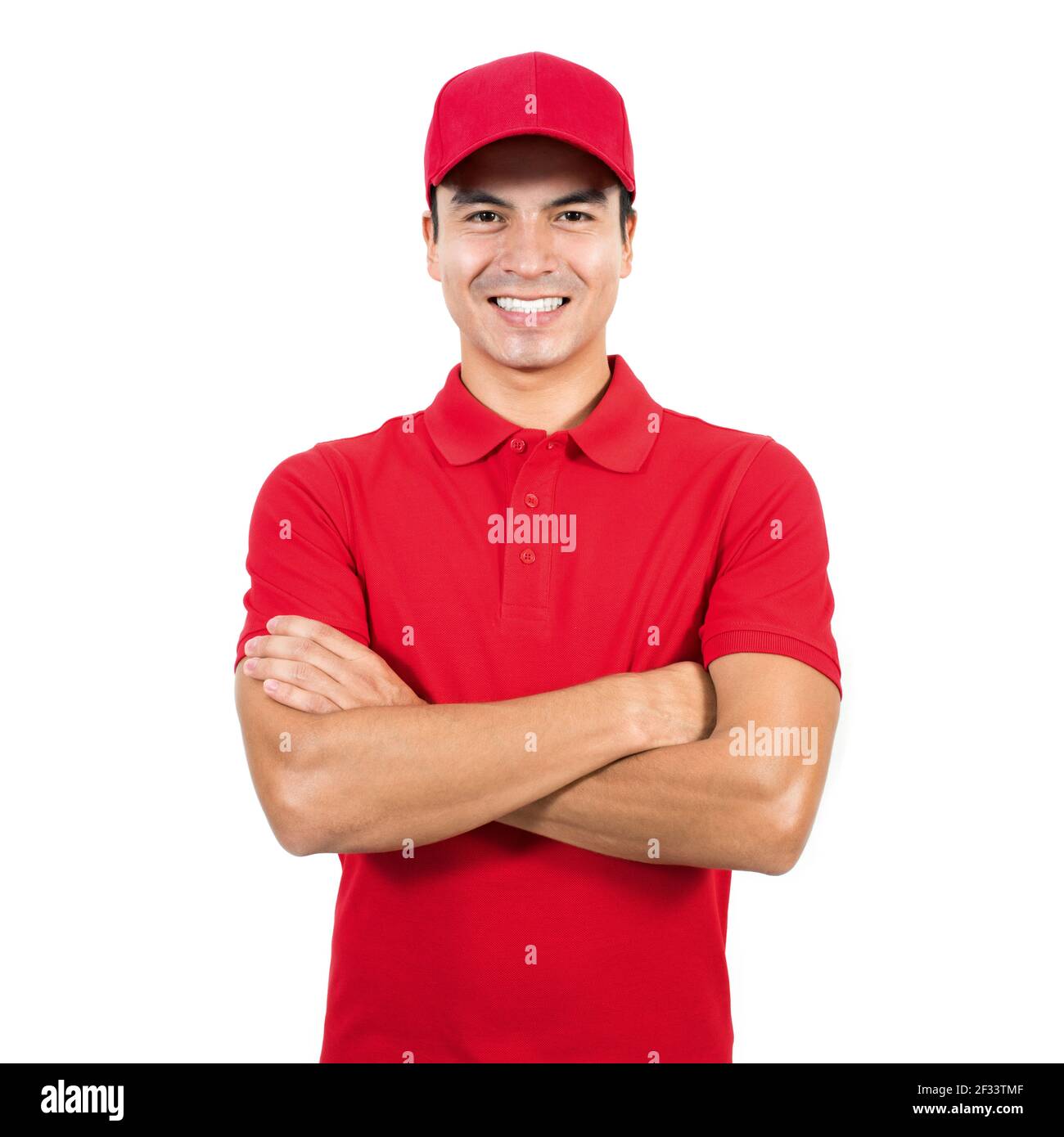 Smiling delivery man in red uniform standing with arm crossed