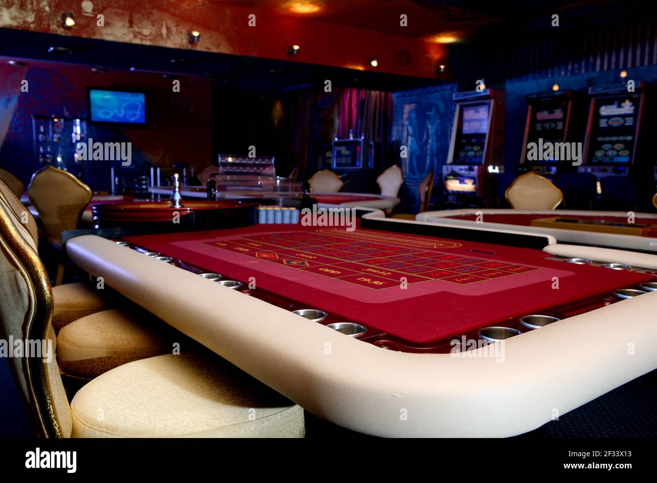 Roulette. The game hall with roulette. Big red table Stock Photo - Alamy