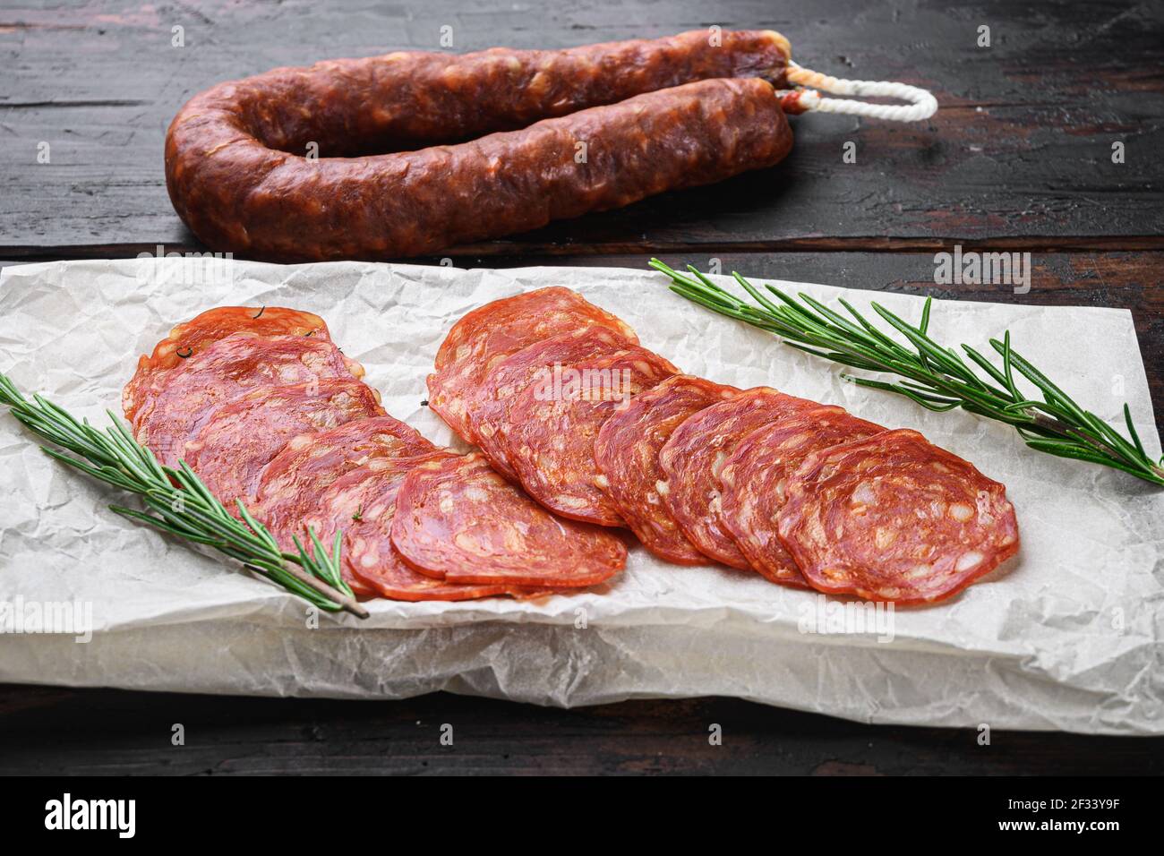 Chorizo, spanish traditional sausage cut to slices on dark wooden ...