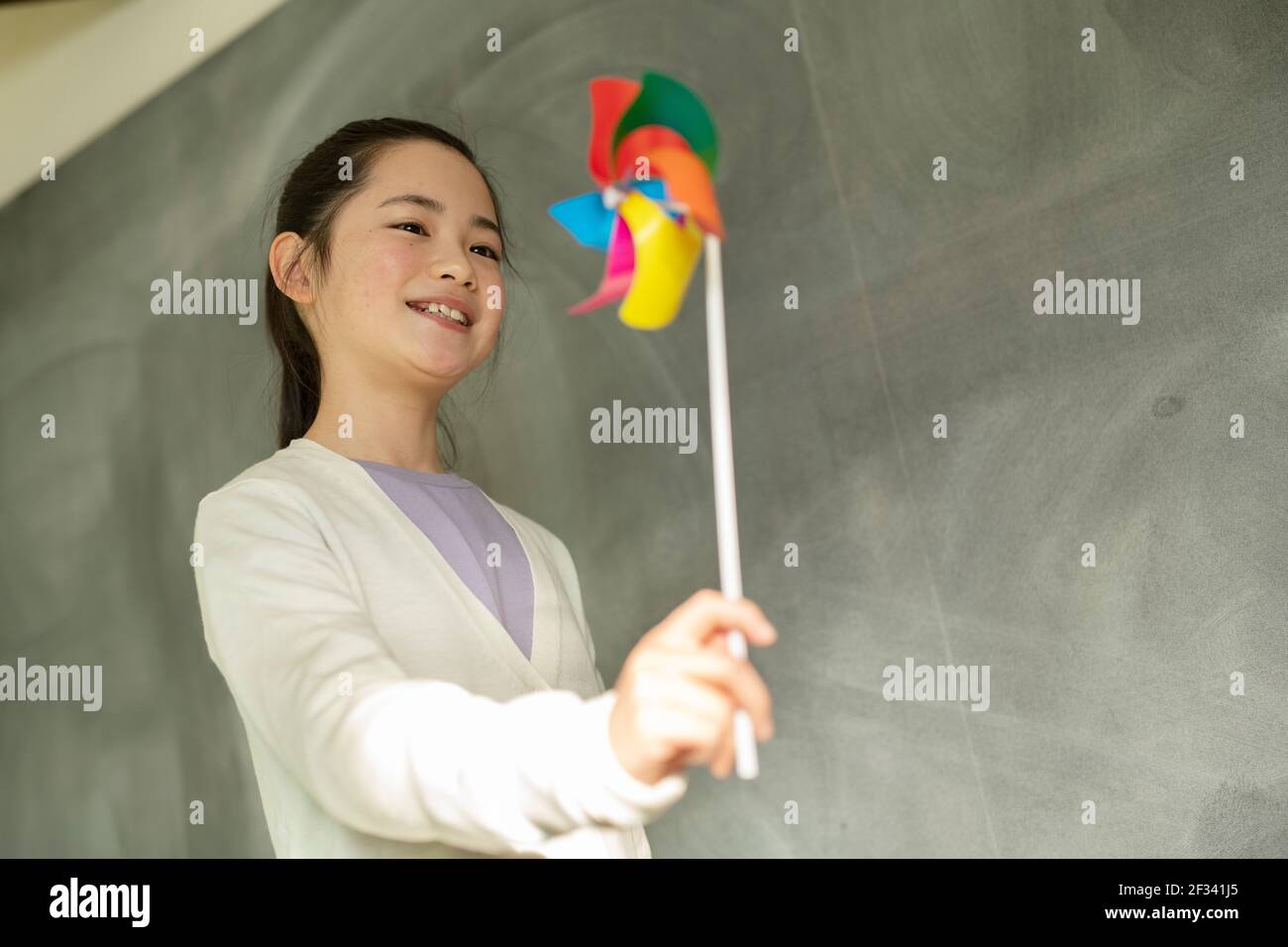Girl with a pinwheel hi-res stock photography and images - Alamy