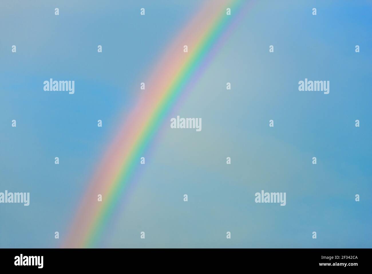 Rainbow in clear blue sky Stock Photo