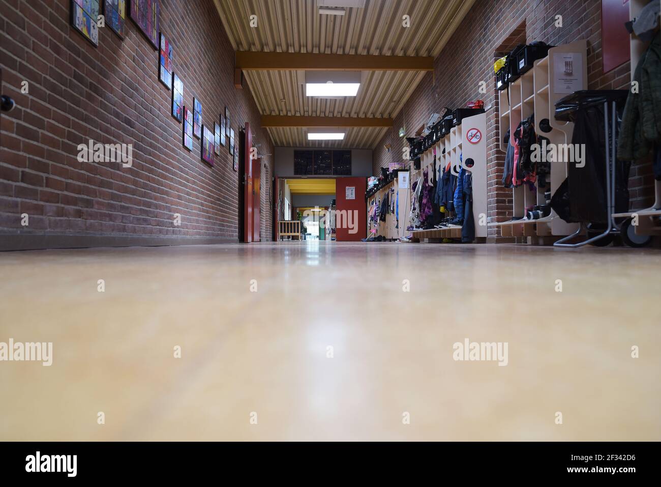 An empty school hallway with wood floors Stock Photo