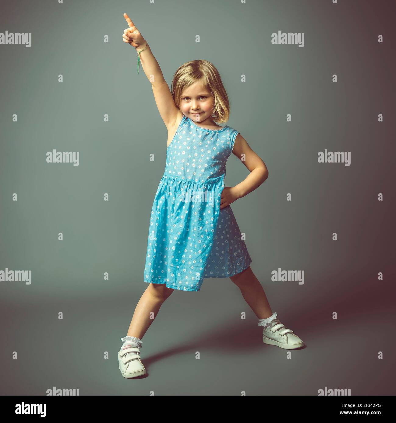 little caucasian girl in ballerina pose. studio shot Stock Photo