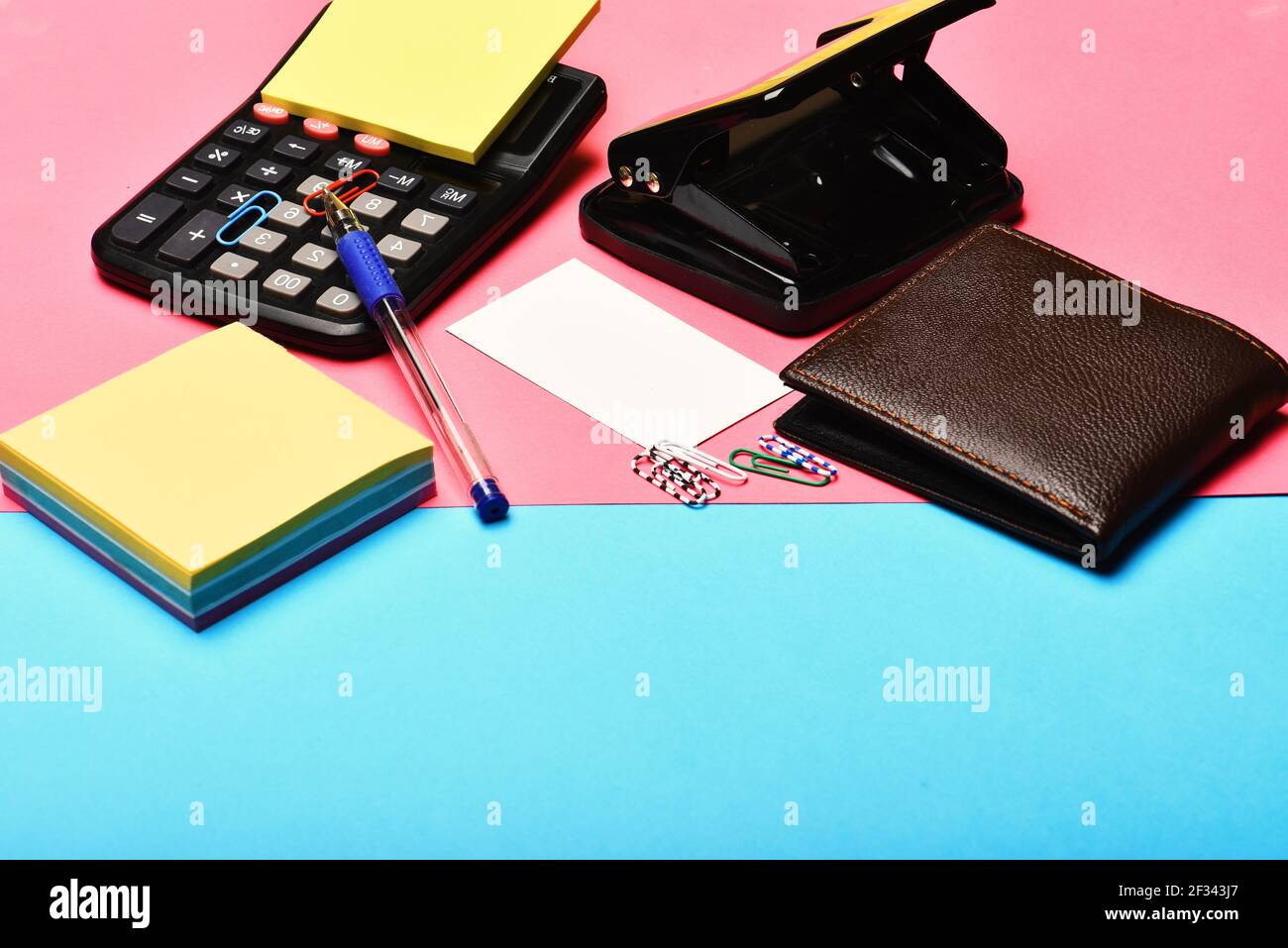 Office tools: calculator, hole punch, card, note paper, pen, clips Stock  Photo - Alamy