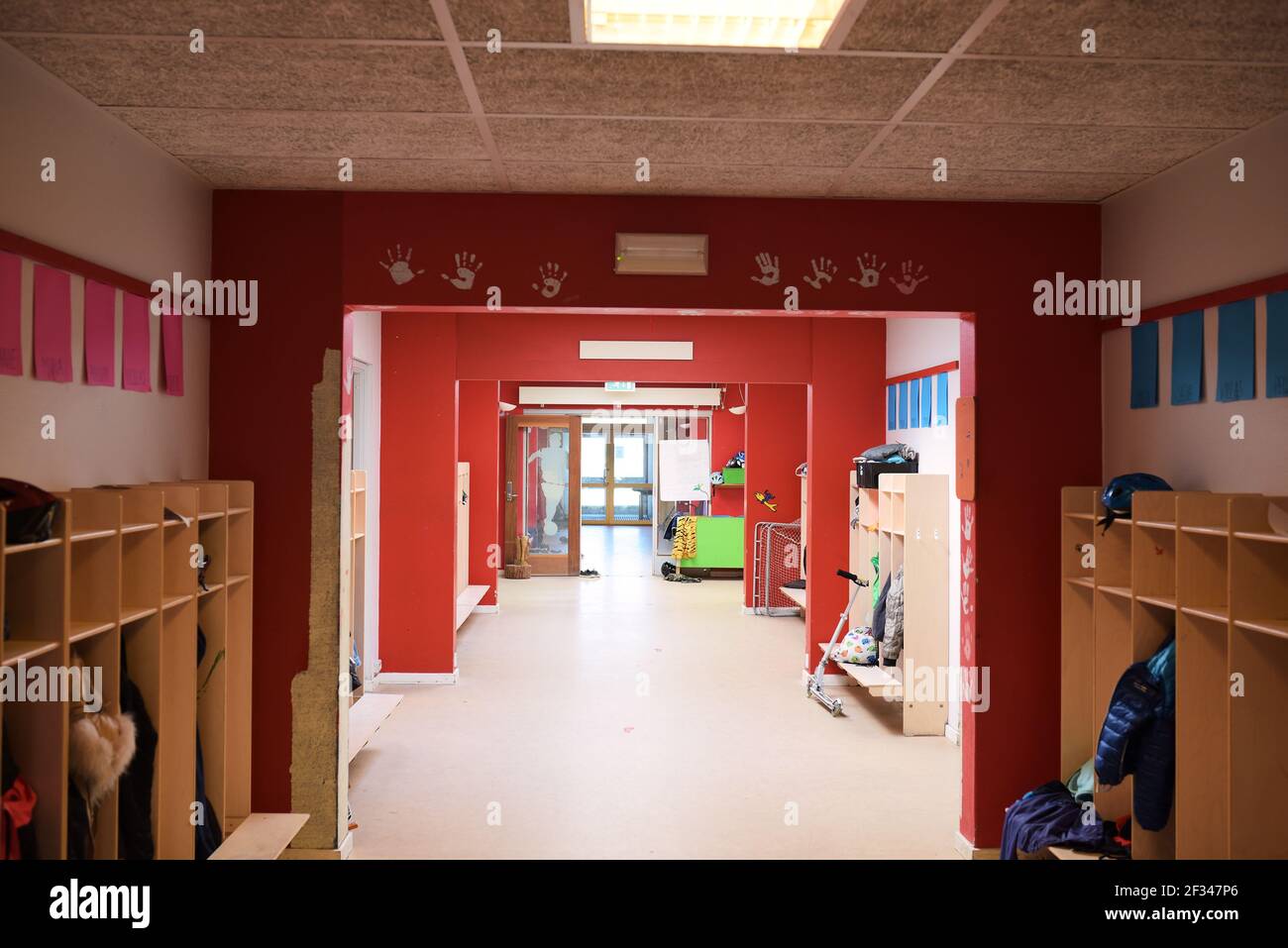 Hallway at school or kindergarten with red walls and doors Stock Photo