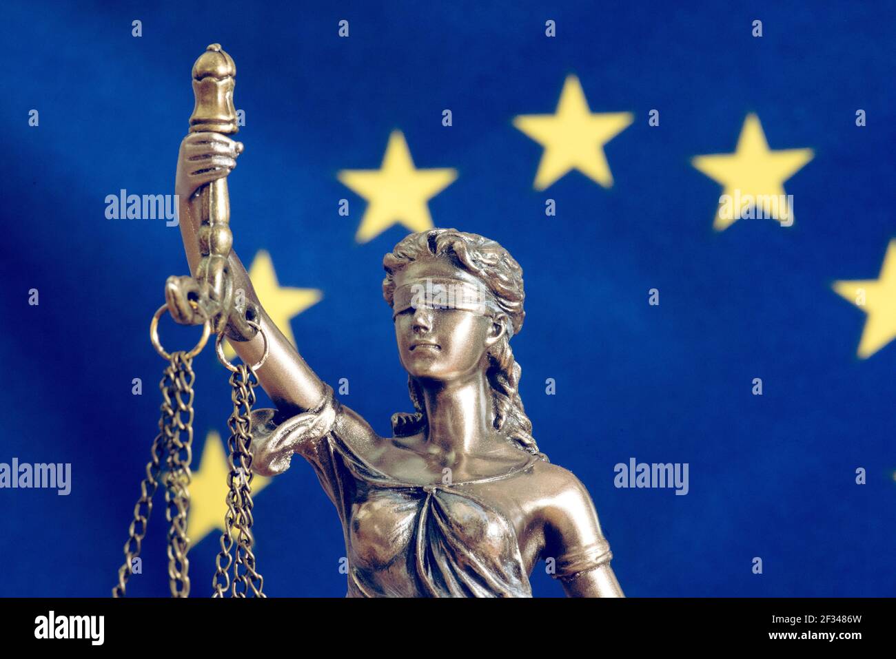 EU flag and Lady Justice statue Stock Photo
