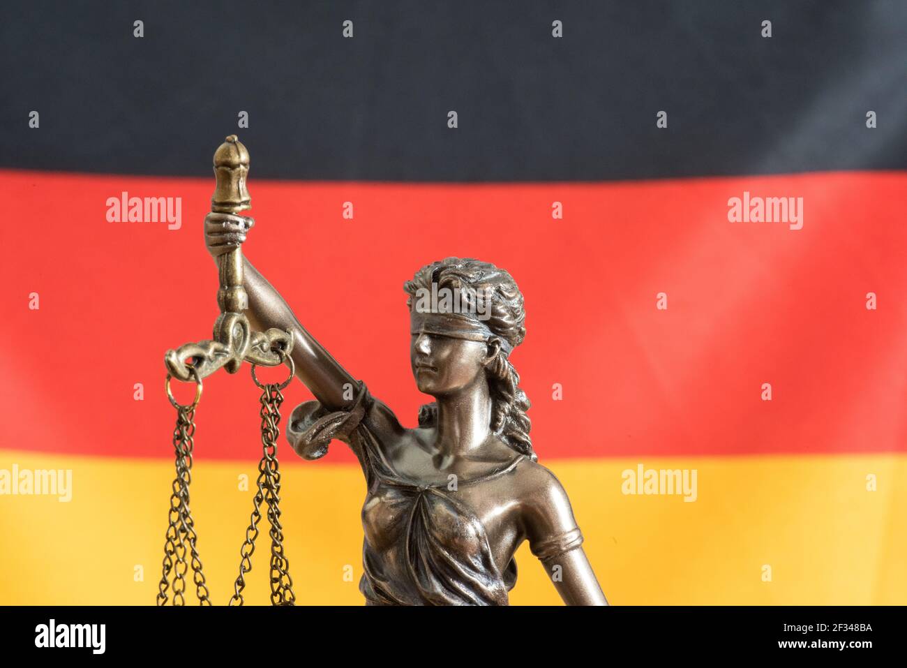 Statue of Justitia and flag of Germany Stock Photo