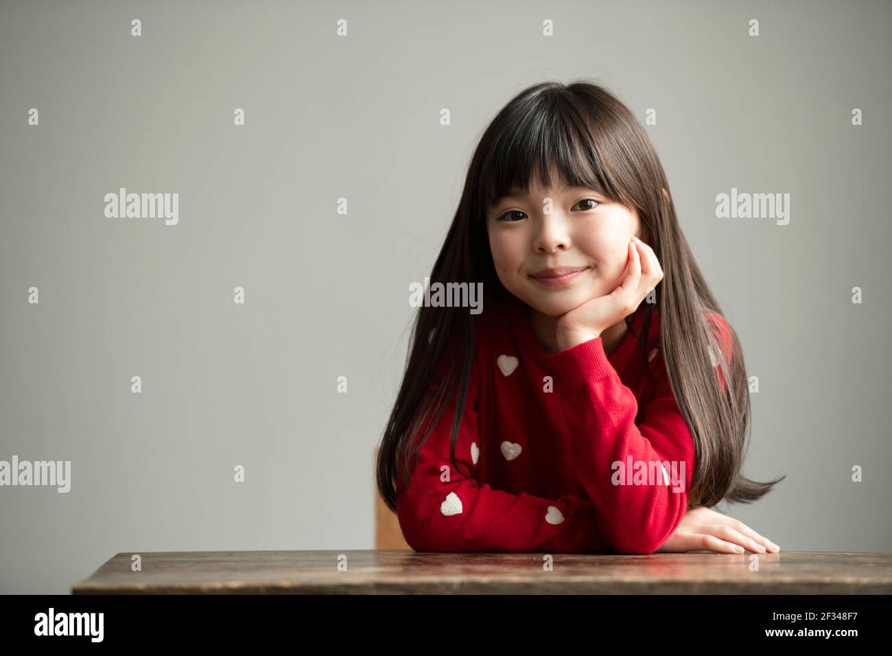 Girl Resting Chin on Hand Stock Photo