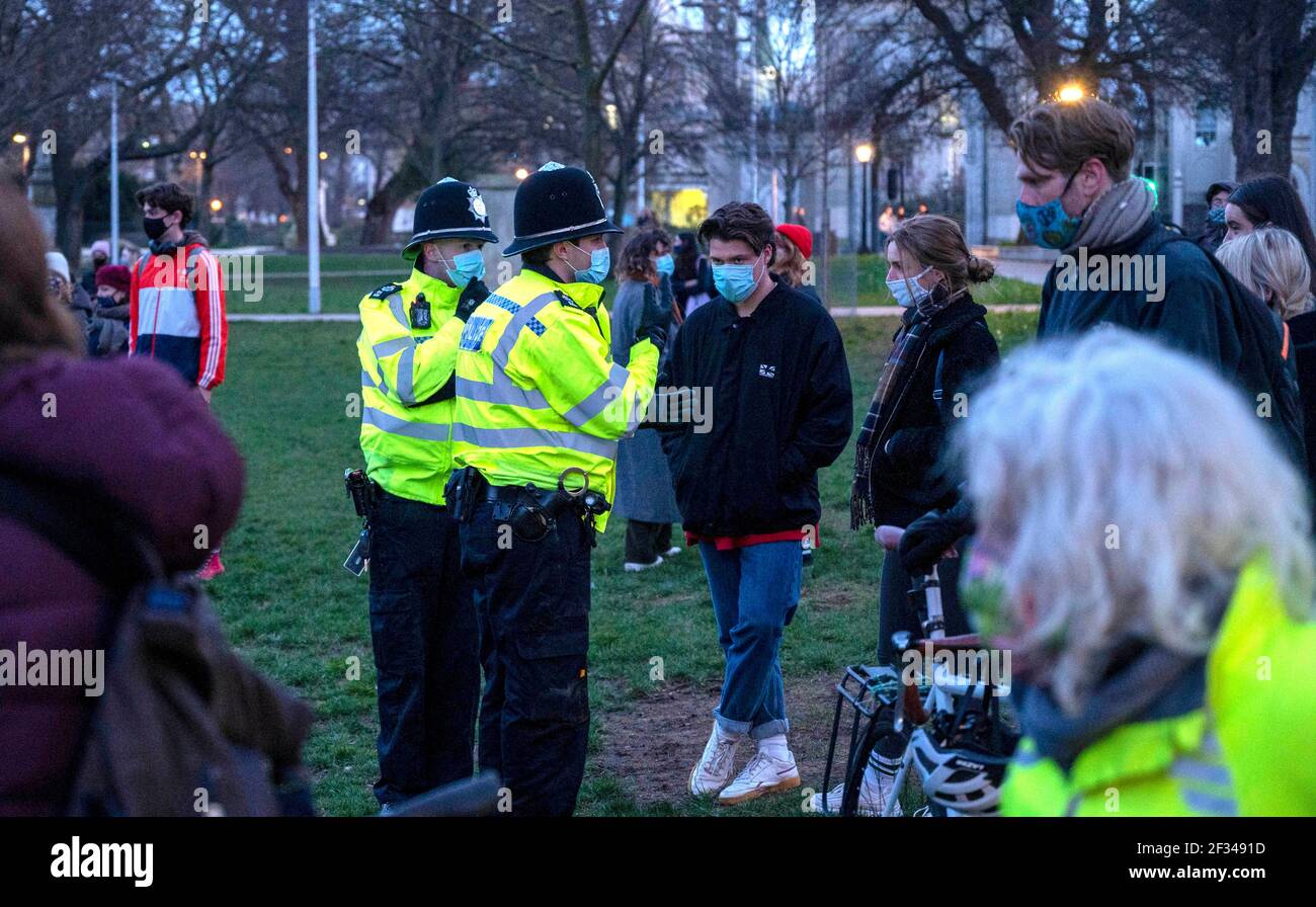 Brighton UK 13th March 2021 - Police start to move people on as hundreds  take part in a candlelit vigil for murder victim Sarah Everard in Brighton this evening . Reclaim These Streets protesters gathered in Brighton's Valley Gardens to take part in the vigil before police started to move them on after about half an hour:  Credit Simon Dack / Alamy Live News Stock Photo
