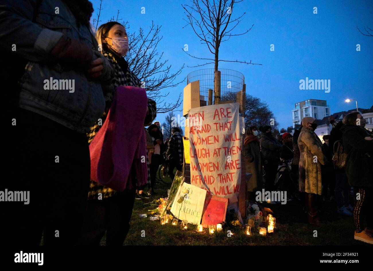 Brighton UK 13th March 2021 - Hundreds of people take part in a candlelit vigil for murder victim Sarah Everard in Brighton this evening . Reclaim These Streets protesters gathered in Brighton's Valley Gardens to take part in the vigil before police started to move them on after about half an hour:  Credit Simon Dack / Alamy Live News Stock Photo