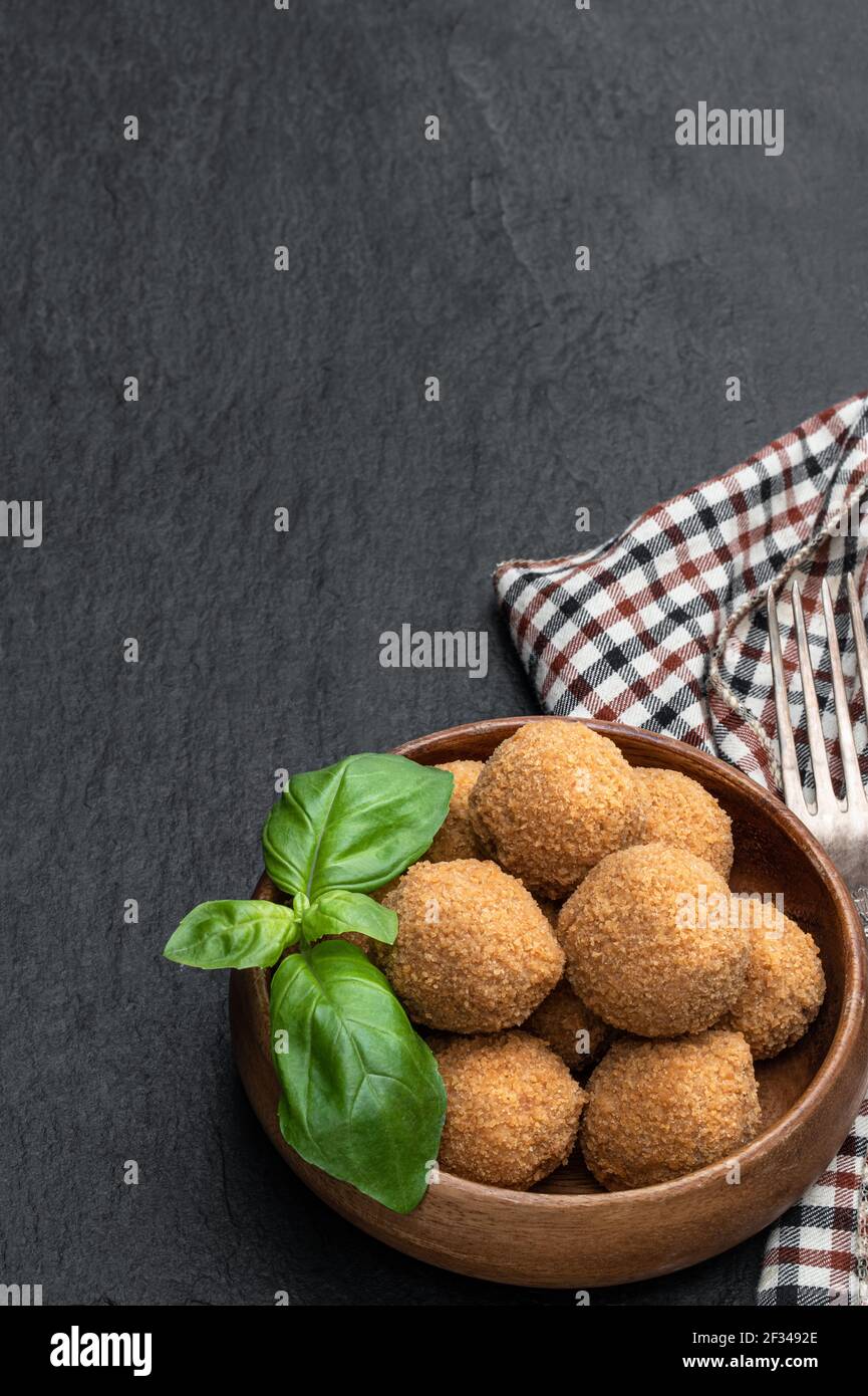 Mini scotch eggs in wooden bowl on black stone background Stock Photo Alamy