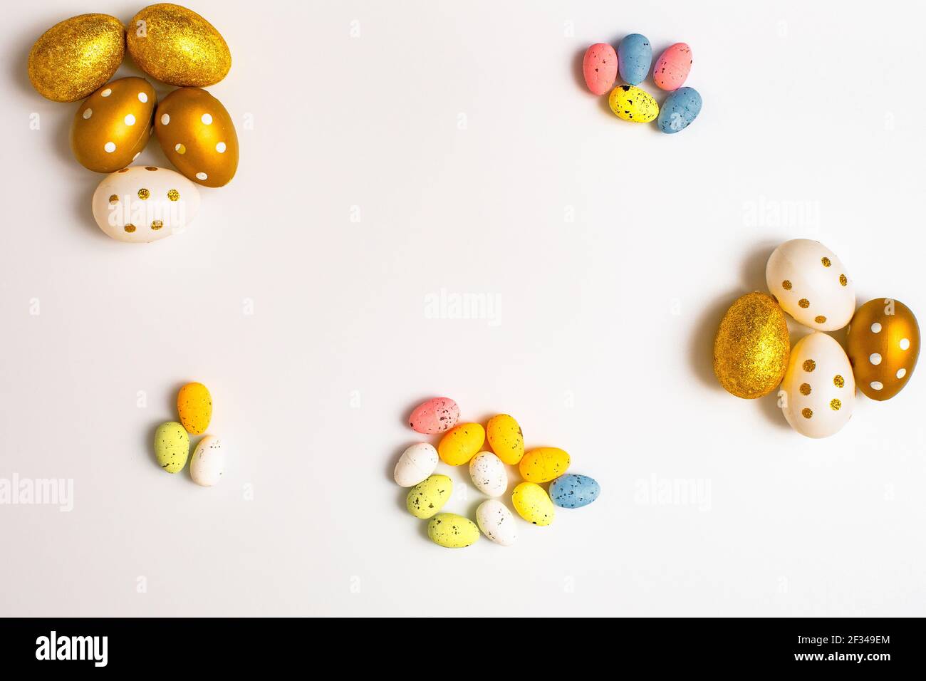 Easter Egg bottom border over a soft white banner background. Top down view with copy space. Stock Photo