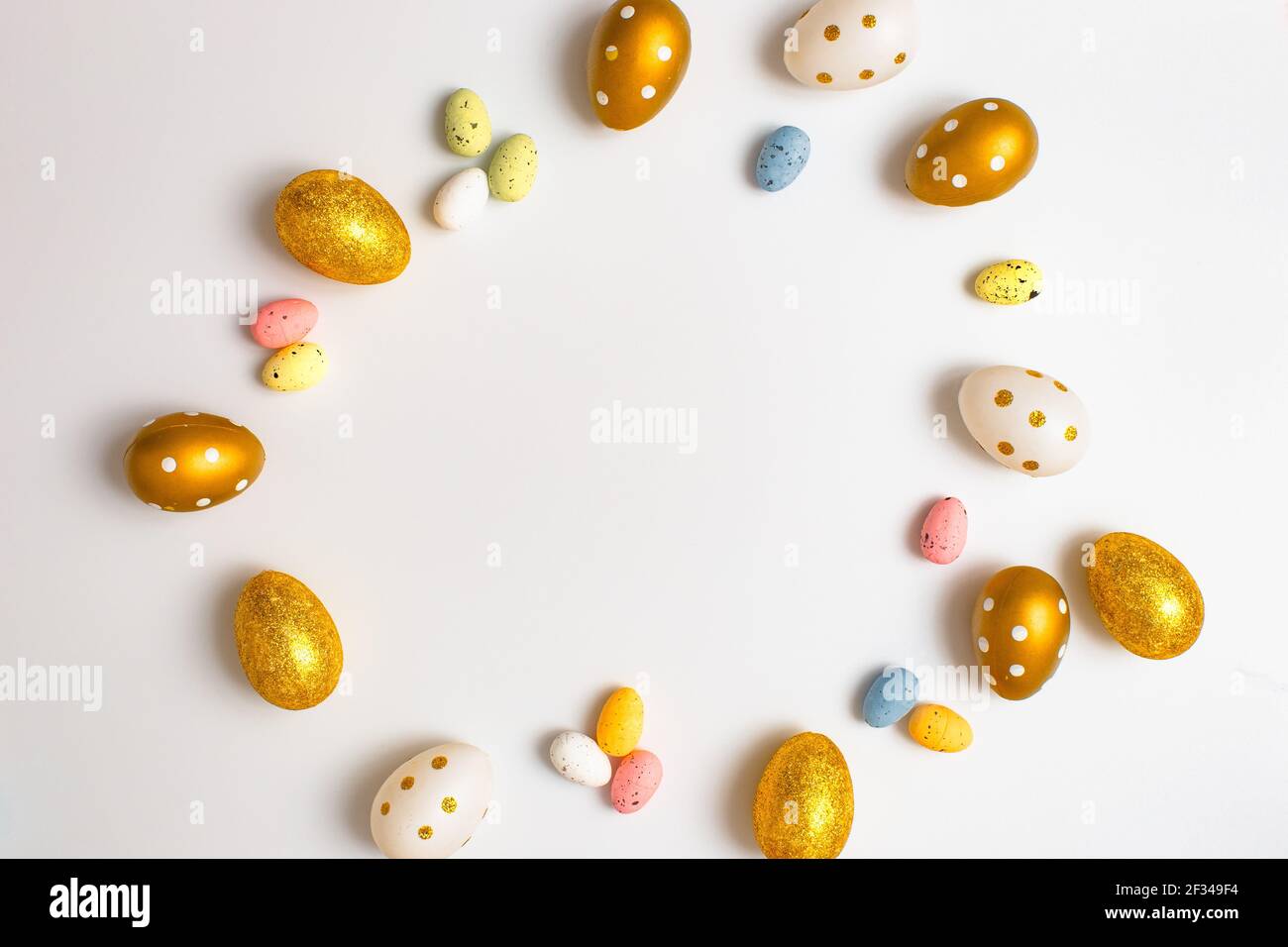 Easter Egg bottom border over a soft white banner background. Top down view with copy space. Stock Photo