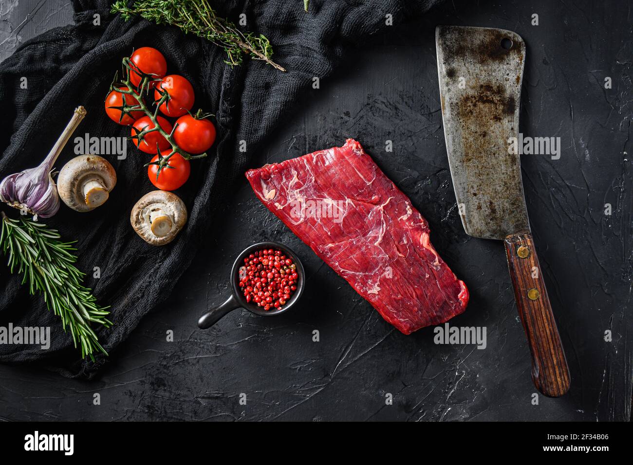 Raw, flap or flank, also known Bavette steak near butcher knife with