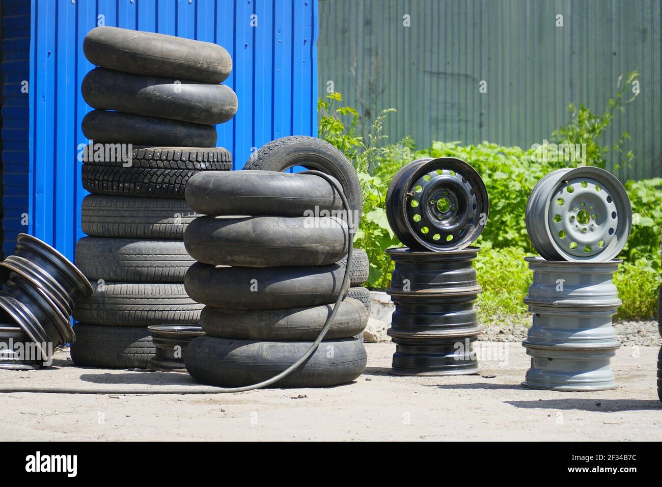 Car tires, rims and tubes or cameras next to the tire shop Stock Photo Alamy