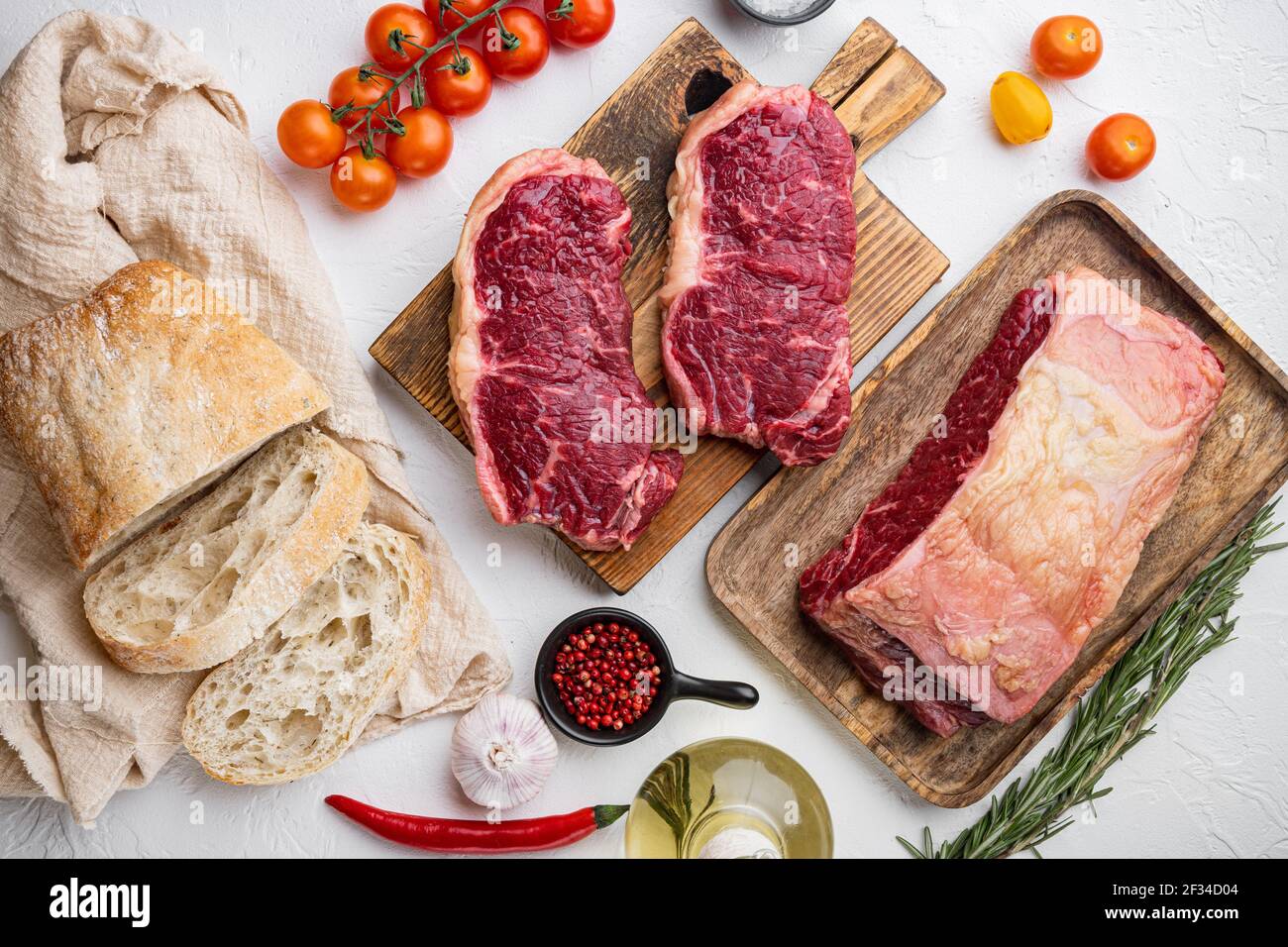 Steak burger ingredients with beef marbled meat, on white background, top view Stock Photo