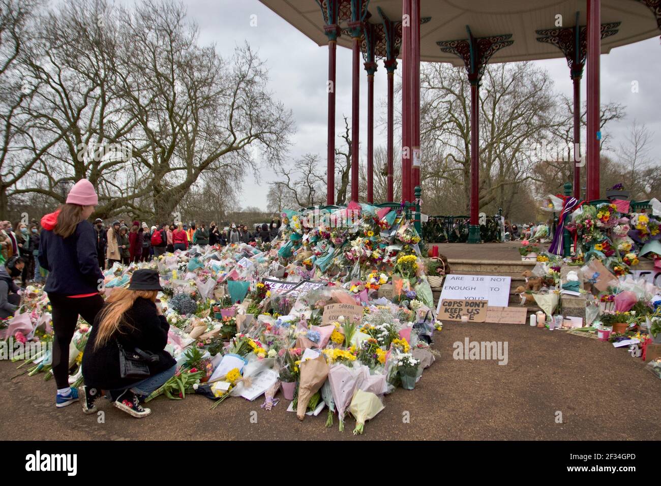 Women placing flowers at Clapham Common Bandstand in tribute to Sarah Everard Stock Photo