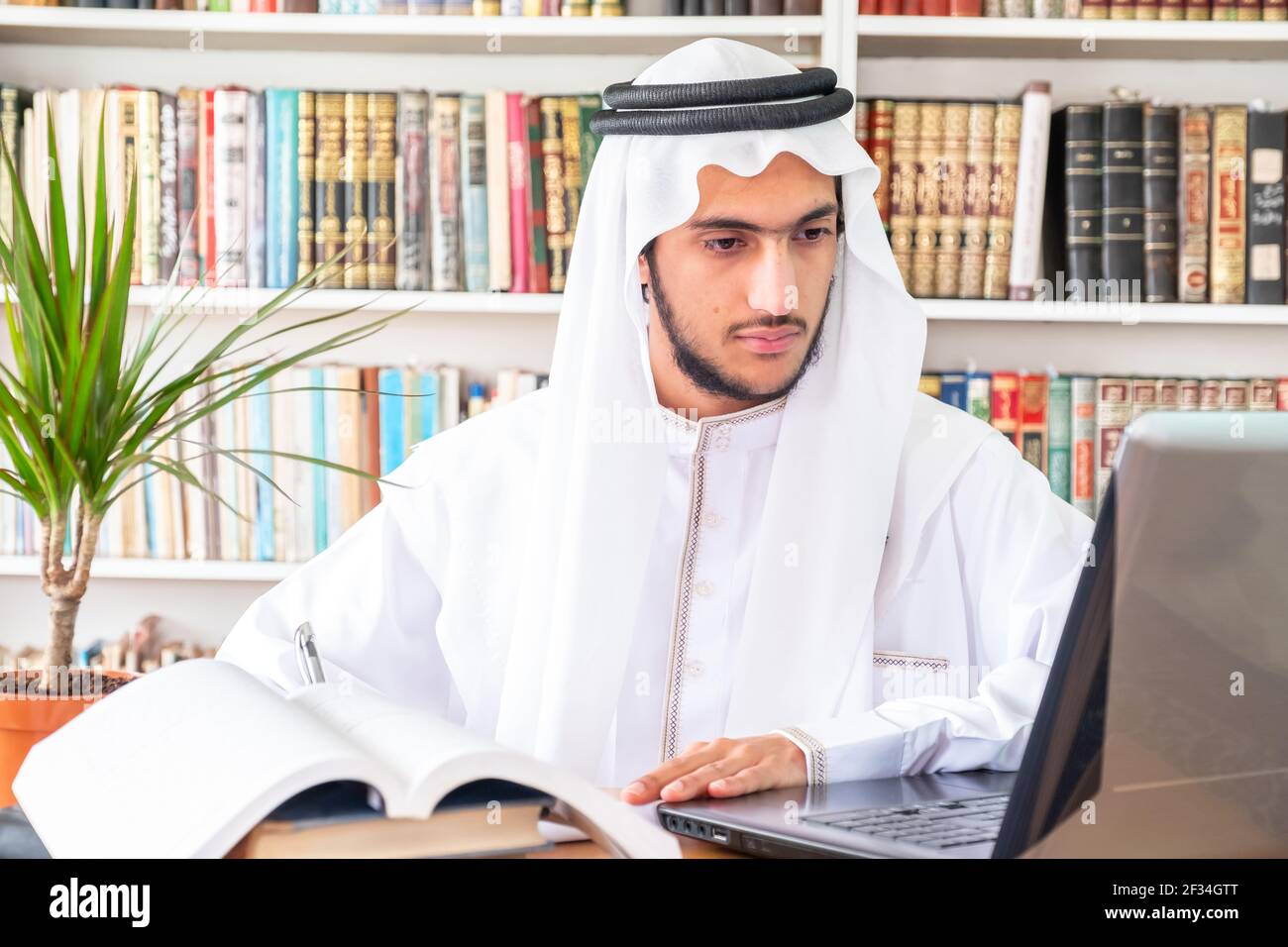 Arabic Muslim student studying online Stock Photo