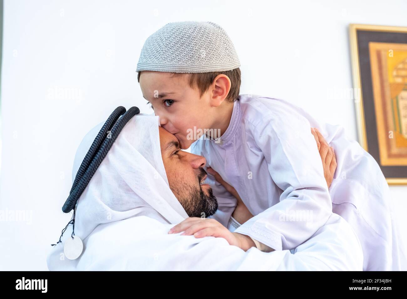 Arabic muslim son kiising his father forehead Stock Photo - Alamy