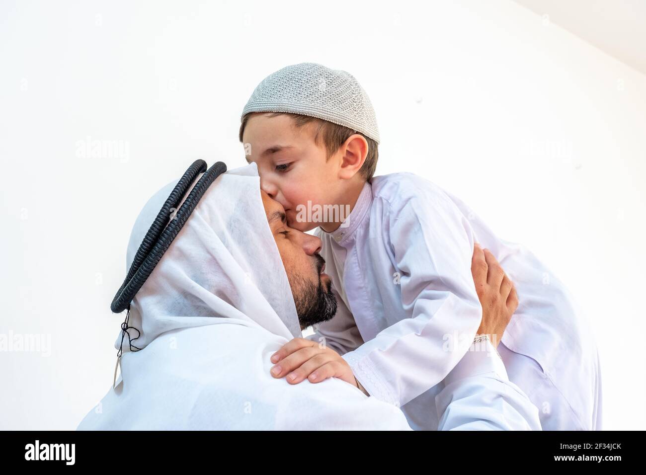 Arabic muslim son kiising his father forehead Stock Photo - Alamy