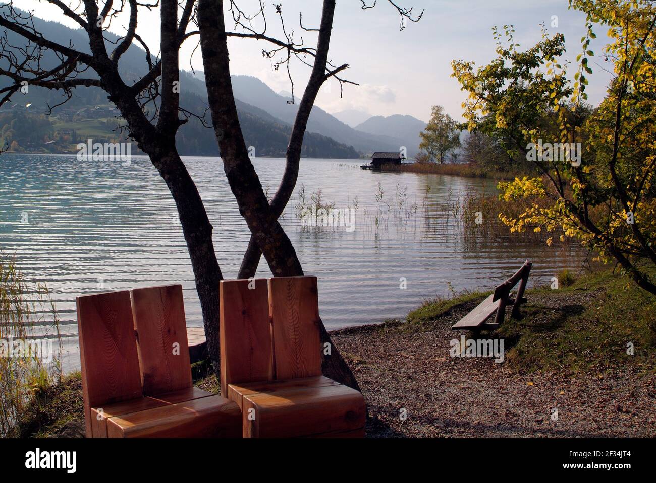 Austria, place to rest with wooden seats on Weissensee lake in Carinthia Stock Photo