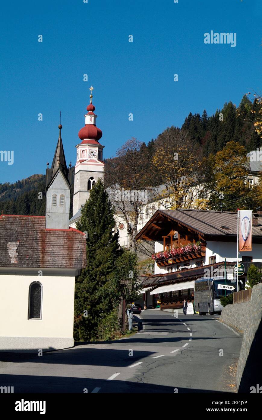 Maria Luggau, Austria - October 13, 2007: Unidentified people, hotel and pilgrimage church in Carinthia Stock Photo