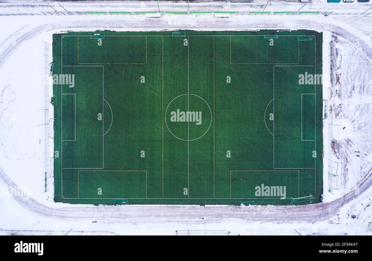 Aerial view of the outdoor football heated field in winter, Finland
