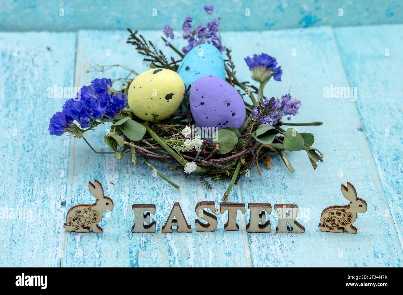 Happy Easter. Easter eggs. Willow twigs. Holy Easter. Blue background. The word Easter. Easter bunny and chicken. Stock Photo