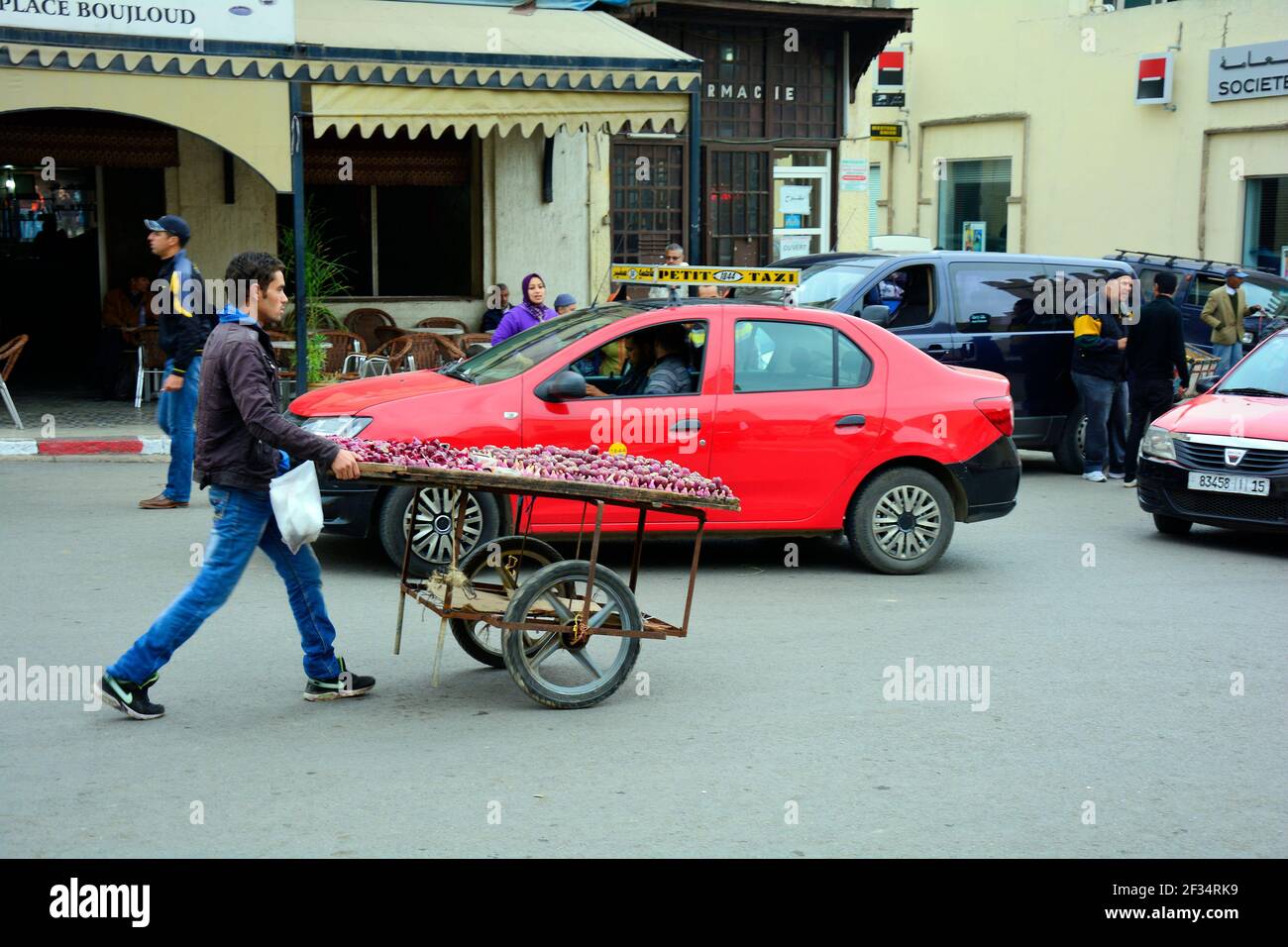 Fez, Morocco - November 20th 2014: Unidentified man with wheel barrow laden with edible fruits of prickly pear cacti on the way to the souk Stock Photo