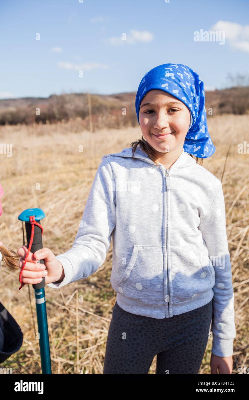 Portrait of adorable hiking little girl on spring day in nature. Stock Photo