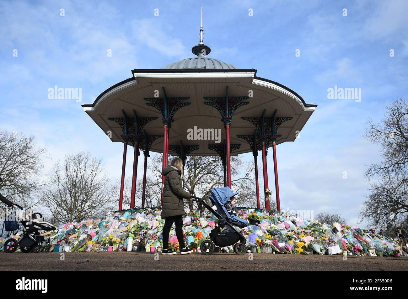 Floral tributes left at the band stand in Clapham Common, London, for murdered Sarah Everard. Serving police constable Wayne Couzens, 48, appeared in court on Saturday charged with kidnapping and murdering the 33-year-old marketing executive, who went missing while walking home from a friend's flat in south London on March 3. Picture date: Monday March 15, 2021. Stock Photo