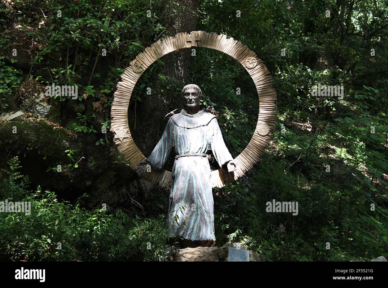 ASSISI, ITALY - JUNE 29, 2014: The statue of St. Francis of Universal Love (S. Francesco dell'Amore Universale) at Eremo dell Carceri made by Sandro D Stock Photo