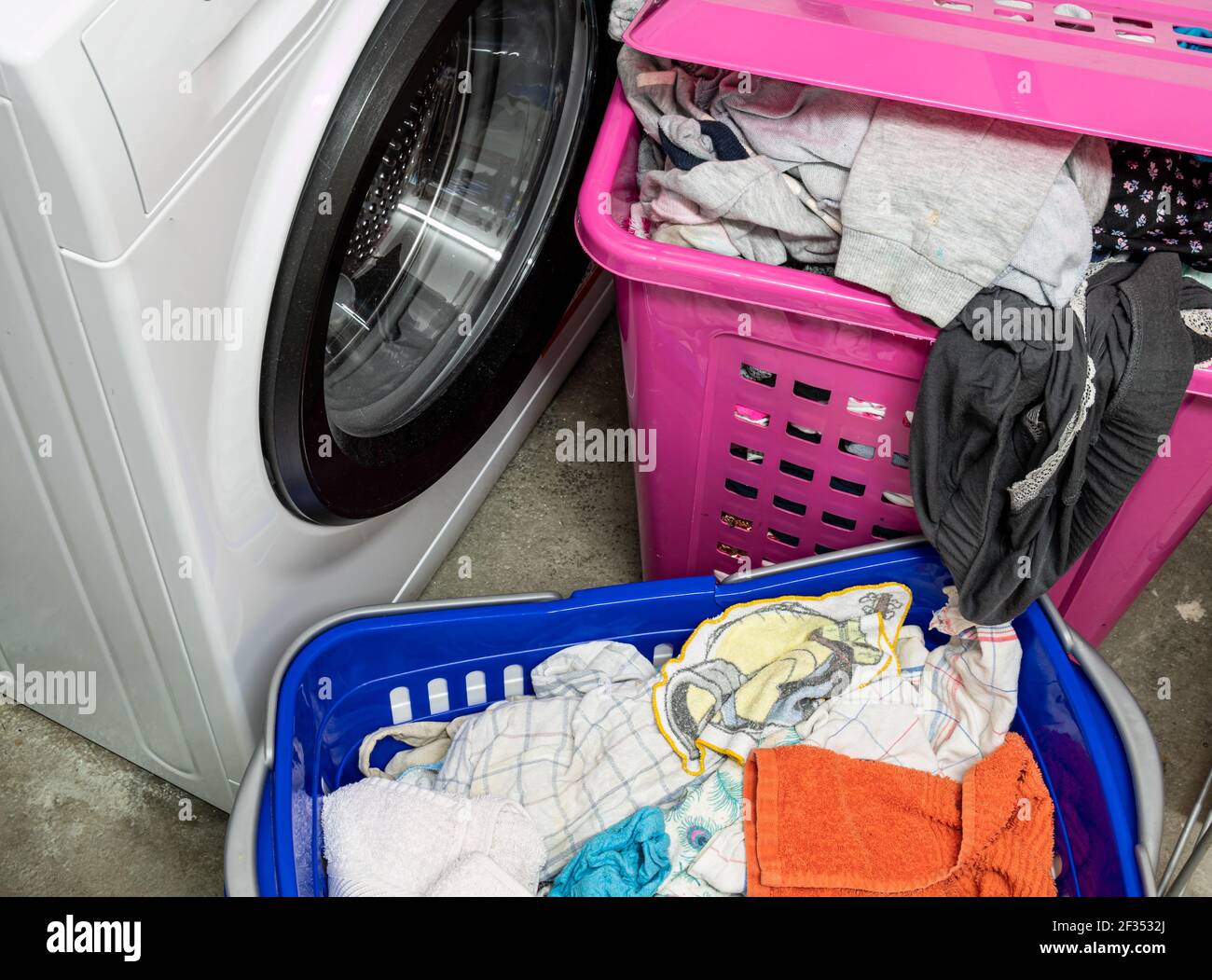 Laundry basket with laundry in the laundry room Stock Photo