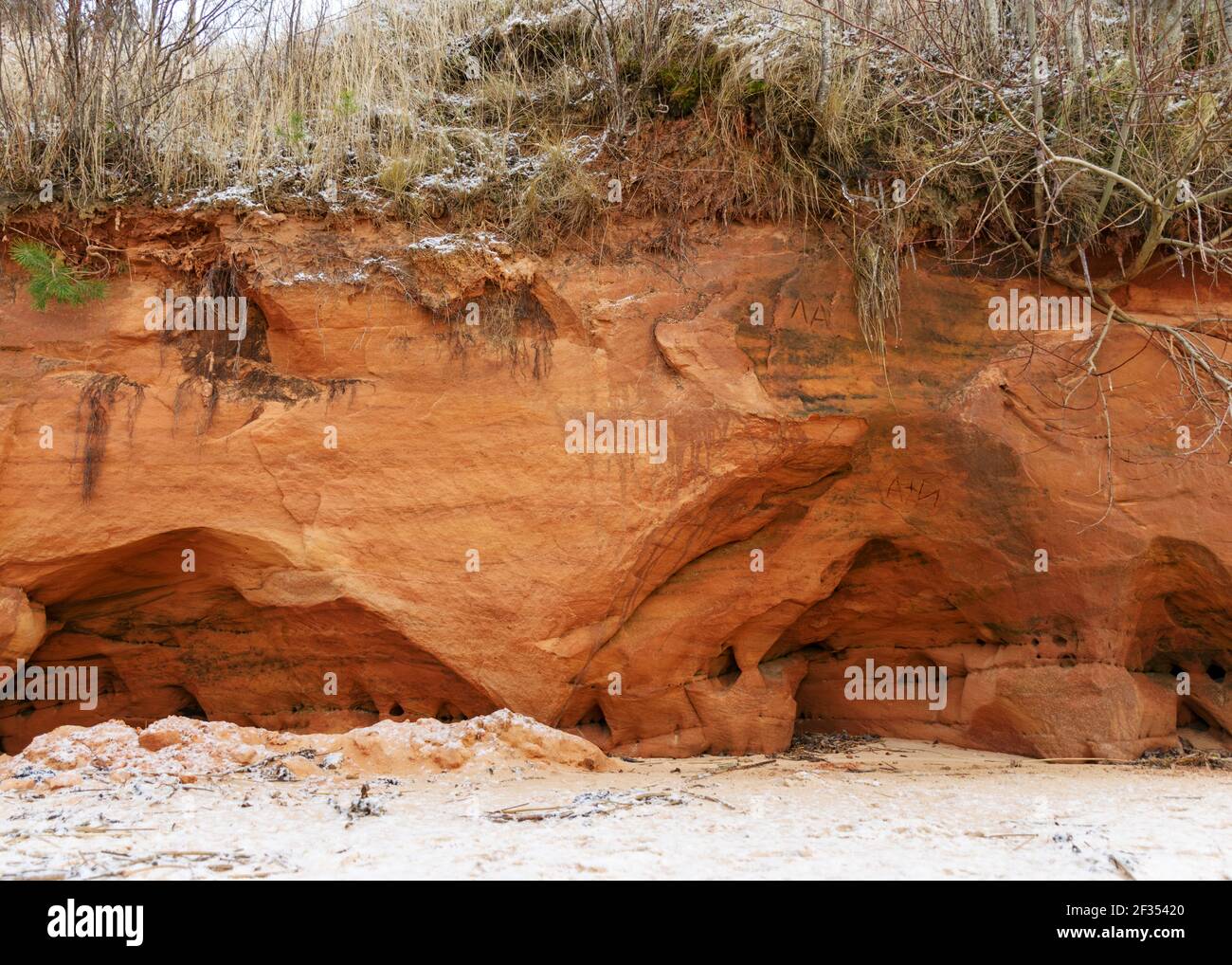 Sea cliff with Devonian sandstone outcrops. During the storm, niches and caves were washed away