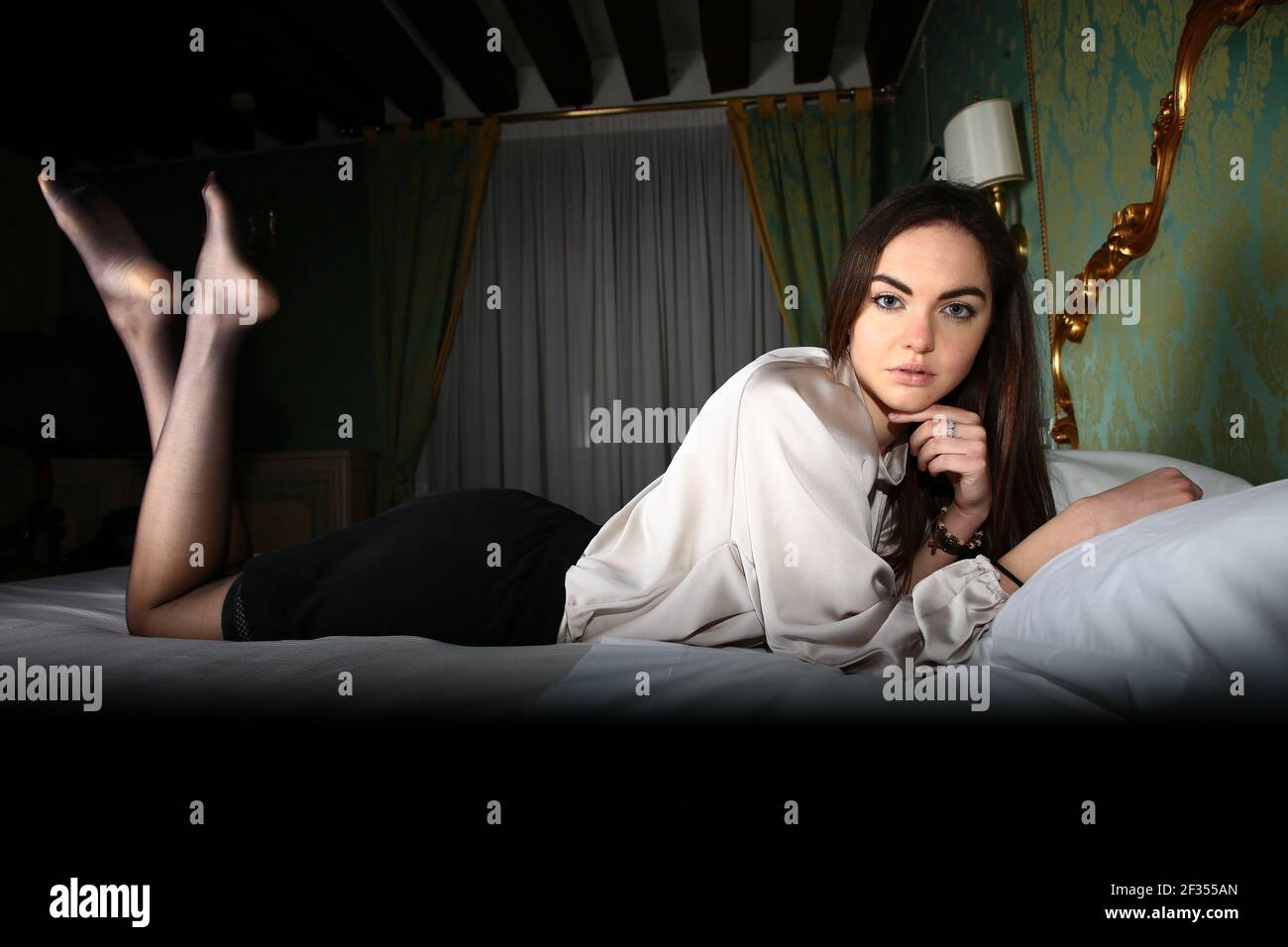 A girl is wearing a pair of black hold ups Stock Photo