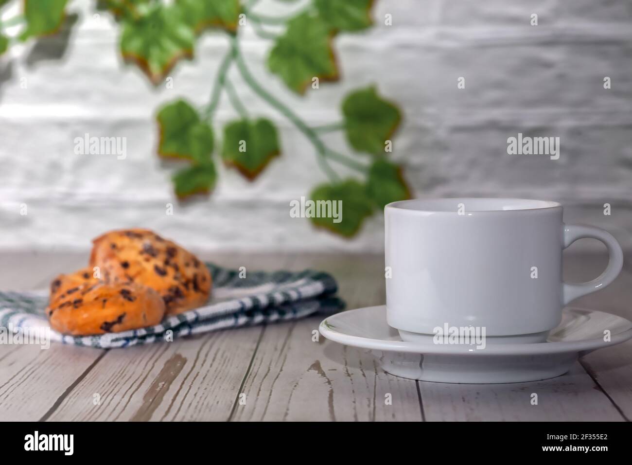 A cup of freshly brewed tea with chocolate chip cookies. Selective focus. Stock Photo