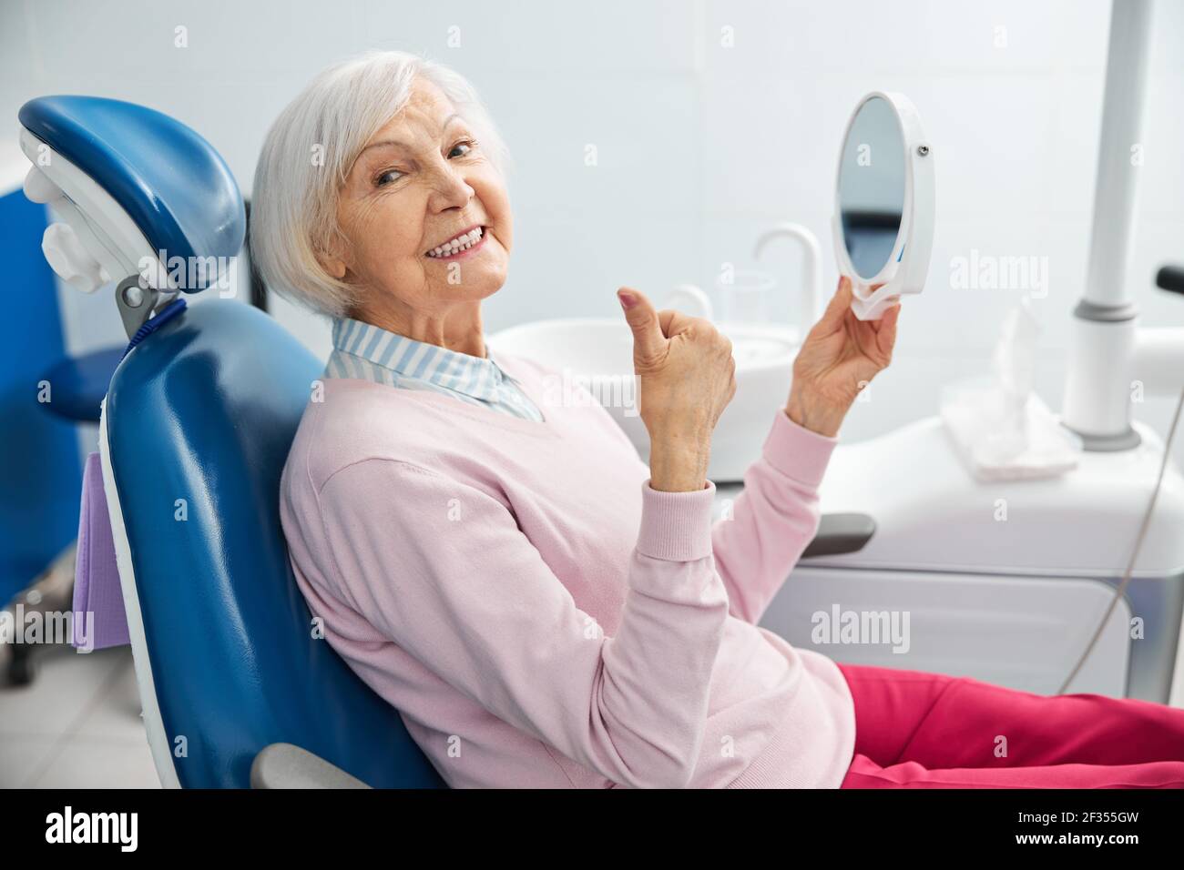 Satisfied pensioner being glad after teeth inspection Stock Photo